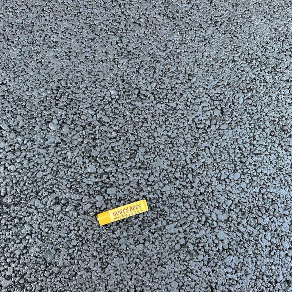 Ultrafine AquaPave Mix - Lip Balm for Scale - Permeable concrete surface close‑up with scale